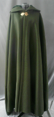 Cloak:1817, Cloak Style:Medium Shaped Shoulder w/ mini Liripipe Hood, Cloak Color:Olive Green, Fiber / Weave:Very Heavy Felted Wool Melton, Cloak Clasp:Geranium Leaves, Hood Lining:Pine Green Silk Velvet, Back Length:53", Neck Length:22", Seasons:Winter, Fall, Spring.