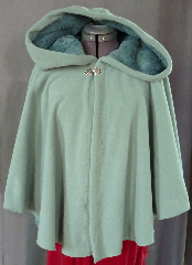 Cloak:2006, Cloak Style:Full Circle Short Cloak, Cloak Color:Seafoam Green, Fiber / Weave:WindPro Polar Fleece, Cloak Clasp:Medallion, Hood Lining:Self-lining, Back Length:26", Neck Length:21", Seasons:Winter, Fall, Spring, Note:The extravagant look and comfort of a full cloak lining<br> without the worry of uneven stretching,<br> plus extraordinary wind resistance!<br> This gorgeous seafoam green short cloak appears<br> to be fully lined with seafoam green fur, <br>but actually it is just one fabric!<br> In fact, it's WindPro Polar Fleece, which is 60-70% wind resistant! <br>This cloak features a full hood and closes with<br> a Medallion hook-and-eye clasp..