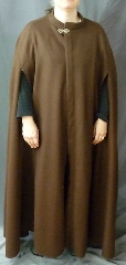 Cloak:2399, Cloak Style:Shaped Shoulder Cloak with arm slits and collar, Cloak Color:Brown, Fiber / Weave:100% wool melton, felted medium weight, Cloak Clasp:Vale - Goldtone, Hood Lining:N/A, Back Length:55", Neck Length:24.5", Seasons:Southern Winter, Fall, Spring, Note:This medium brown, shaped shoulder cloak is made from a<br>felted wool thick enough to have some<br>wind and water resistance.  With a<br>small band collar and front arm openings,<br>the cloak has a more formal air.<br>Sturdy and durable, this cloak will stand up to<br>mild winter  weather.  Dry Clean only..