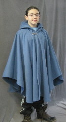 Cloak:2607, Cloak Style:Cape / Ruana extra long (30") over the shoulder, Cloak Color:Colonial Blue, Fiber / Weave:WindPro Herringbone Fleece (wool-like exterior), Cloak Clasp:Vale, Hood Lining:Self-lining, Back Length:35", Neck Length:23", Seasons:Winter, Fall, Spring, Note:A cross between a cape and a cloak, a ruana<br>is a great way to keep warm while<br>frequent, unhindered use of your arms <br>is needed. Ruanas make great driving cloaks!<br>Note, the model is 4' 10".