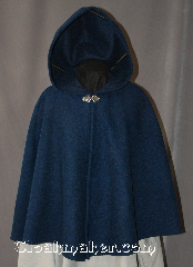 Cloak:2934, Cloak Style:Shaped Shoulder Cloak - Short, Cloak Color:Sapphire Blue and Black, Fiber / Weave:80% Wool / 20% Nylon, Cloak Clasp:Vale, Hood Lining:Unlined, Back Length:27", Neck Length:21.5", Seasons:Fall, Spring, Southern Winter, Note:This heathered black and sapphire blue<br> felted shaped shoulder short cloak<br>is a great conversation piece<br>with woven texture that results<br>in subtle variations of color under<br>different lighting.<br>Made of a medium weight wool blend,<br>it is a wonderful cloak for cool<br>evenings in the fall or spring,<br>and is accented with a<br>silver tone Vale clasp.<br>This cloak is sized for<br>young adults and older.<br>Dry Clean only..