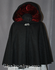 Cloak:2941, Cloak Style:Full Circle Short Cloak, Cloak Color:Black, Fiber / Weave:80% Wool/20% Cashmere, Cloak Clasp:Vale, Hood Lining:Cranberry Red Velvet, Back Length:24.5", Neck Length:21", Seasons:Fall, Spring, Southern Winter, Note:Perfect Starter cloak for a child or a<br>fashionable alternative to a shawl.<br>This black short cloak is made of<br>80% Wool/20% Cashmere<br>and feels like soft felt.<br>The Cranberry velvet lined hood<br>and silver vale clasp complete<br>the look for cool evening.<br>A fun addition to any wardrobe.<br>Dry Clean Only..