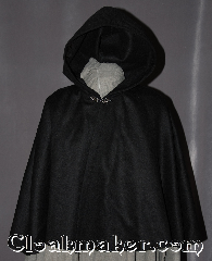 Cloak:2952, Cloak Style:Shaped Shoulder Cloak - Short, Cloak Color:Black, Fiber / Weave:100% Wool, Cloak Clasp:Antiquity, Hood Lining:Unlined, Back Length:21.5", Neck Length:18.5", Seasons:Fall, Spring, Note:Perfect Starter cloak for a child<br>or a fashionable alternative<br>to a shawl.<br>This black short cloak<br>is made of a 100% wool with a silver tone antiquity<br>hook and eye clasp completes<br>the look for cool evenings.<br>A fun addition to any wardrobe.<br>Dry Clean Only.<br>Pictured with robe R285 sold separately..