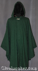 Cloak:3331, Cloak Style:Shaped Shoulder Ruana Cloak<br>with wand pocket, Cloak Color:Hunter Green, Fiber / Weave:100% Wool Melton, Cloak Clasp:Vale, Hood Lining:Long pile brown velvet, Back Length:45" back<br>31.5" overarm, Neck Length:21.5", Seasons:Fall, Spring, Southern Winter, Winter, Note:The wizard's special ruana cloak with<br>hidden wand pocket in the front edge.<br>A cross between a cape and a cloak,<br>a shape shoulder ruana is a great way <br>to keep warm while frequent, unhindered<br>use of your arms is needed.<br>Made with  a fitted shoulder for less bulk<br>and a long pile brown velvet lined<br>hood with vale clasp closure.<br>Ruanas make great driving cloaks!<br>Handwash cold..