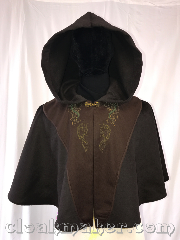 Cloak:3588, Cloak Style:Full Circle Cloak, Cloak Color:Brown, Fiber / Weave:Wool, Cloak Clasp:Special Gold, Hood Lining:Unlined, Back Length:20", Neck Length:20", Seasons:Spring, Fall, Southern Winter, Winter, Note:Black with brown tunic panels with<br>green celtic and horses embroidery.<br>Dry clean only..