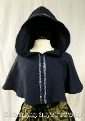 Cloak:3633, Cloak Style:Full Circle Cloak, Cloak Color:Light Navy Blue, Fiber / Weave:Wool Suiting, Cloak Clasp:Snaps, Hood Lining:Unlined, Back Length:16", Neck Length:22", Seasons:Spring, Summer, Fall, Note:This short full circle cloak is a<br>light navy blue color<br>and secures with snaps.<br>It is paired with the 'Florentine, Narrow<br>in Silver, blue, & red' trim.<br>Dry clean only.