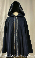 Cloak:3672, Cloak Style:Shaped Shoulder Cloak, Cloak Color:Navy Blue, Fiber / Weave:Windpro Fleece<br>from Malden Mills, Cloak Clasp:three snaps, Hood Lining:unlined, Back Length:34", Neck Length:21", Seasons:Winter, Southern Winter, Fall, Spring, Note:This navy blue shaped shoulder cloak<br>has a flirty hem and<br>is secured by three snaps.<br>Complimented by our "Running Mosaic<br>Vine in Silver/Blue" trim.<br>Wind blocking fleece material,<br>machine wash cold using mild<br>detergent and tumble dry on low..