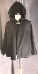 Cloak:3888, Cloak Style:Multi-panel Short, Cloak Color:Black, Fiber / Weave:Wool, Cloak Clasp:Vale, Hood Lining:unlined, Back Length:31.5", Neck Length:21", Seasons:Spring, Fall, Southern Winter, Note:Dashing multi-panel short cloak of<br>black wool with a pewter vale clasp<br>will dignify your shoulders<br>or could be a starting cloak for a child..