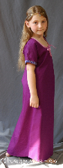 Gown ID:G908, Gown Color:Orchid Purple, Style:Child Dress 12th century, Sleeve:Short Sleeve with Medallion, Narrow Purple & Pink trim, Trim:Medallion, Narrow Purple & Pink trim on sleeves, Neckline Type:Keyhole trimmed with pink ties, Fabric:Cotton, Sleeve Length:11.5", Back Length:39.