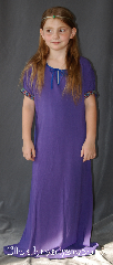Gown ID:G909, Gown Color:Purple, Style:Child Dress 12th century, Sleeve:Short Sleeve with Fantasia, Purple/Teal trim, Trim:Fantasia, Purple/Teal trim on the sleeves, Neckline Type:Keyhole trimmed with blue ties, Fabric:Cotton, Sleeve Length:12", Back Length:45".