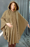 A woman in a heathered light brown wool Cape/Ruana, which can be made in fleece and other fabrics in other colours.