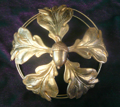 A unique handmade soldered brass bun cover decorated with oak leaves and acorns.