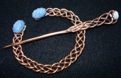 Thick copper braid
                        with faux opals Penannular