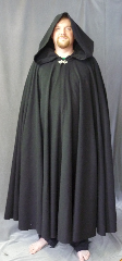 Cloak:3042, Cloak Style:Full Circle Cloak, Cloak Color:Black, Fiber / Weave:80% Wool / 20% Nylon, Cloak Clasp:Vale, Hood Lining:Unlined, Back Length:56", Neck Length:20", Seasons:Fall, Spring, Note:This black full circle cloak<br>has a slightly rougher texture<br>with a classic look.<br>Perfect for cooler evenings<br>and accented with a silvertone<br>Vale hook-and-eye clasp.<br>Dry clean only..